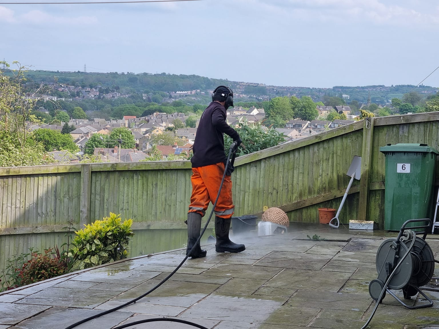 Mow & Glow pressure washing a patio in West Yorkshire